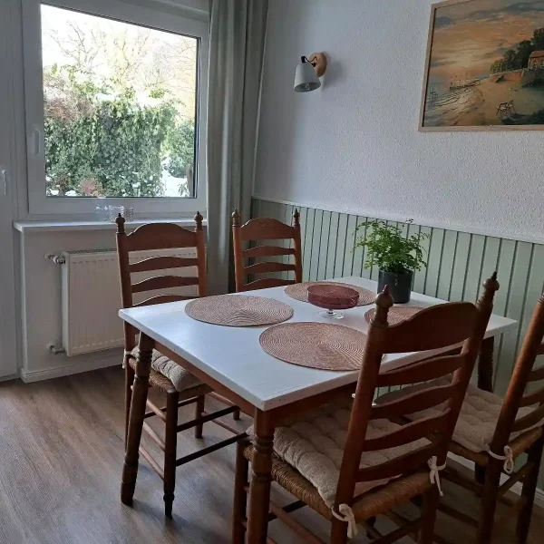 Urlaub im Grünen: Lichtdurchfluteter Essbereich im Landhausstil mit direktem Blick in den Garten von Rastede.